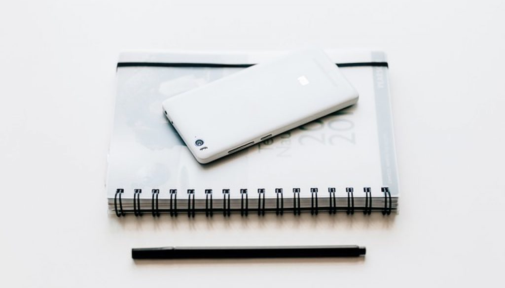 black and white notebook and pen